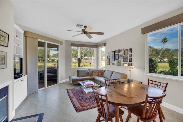 interior space featuring visible vents, a ceiling fan, and baseboards