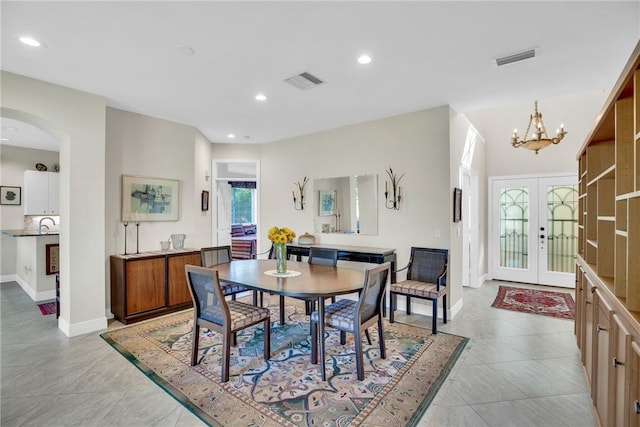 dining room with arched walkways, french doors, visible vents, and recessed lighting