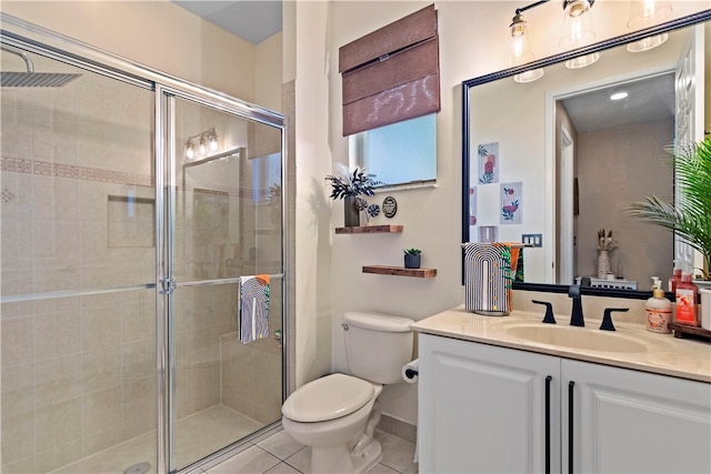 bathroom featuring vanity, tile patterned floors, an enclosed shower, and toilet