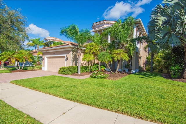 mediterranean / spanish home with a front yard and a garage