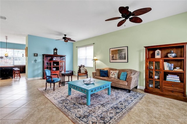 living room with light tile patterned floors and ceiling fan