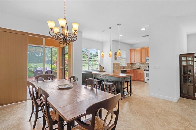 2019 Grey Falcon Cir SW, Vero Beach, FL 32962 - dining area with a chandelier, light tile patterned floors, and recessed lighting