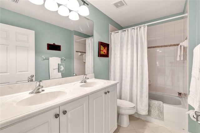 2019 Grey Falcon Cir SW, Vero Beach, FL 32962 - bathroom with tile patterned floors, toilet, double vanity, and shower / bath combo with shower curtain