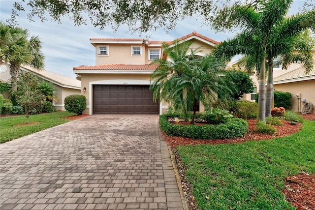 mediterranean / spanish-style home with a garage and a front lawn