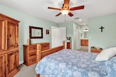 2019 Grey Falcon Cir SW, Vero Beach, FL 32962 - bedroom featuring light carpet, ensuite bath, recessed lighting, and a ceiling fan