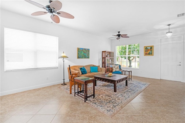 2019 Grey Falcon Cir SW, Vero Beach, FL 32962 - living room with ceiling fan, baseboards, and light tile patterned floors