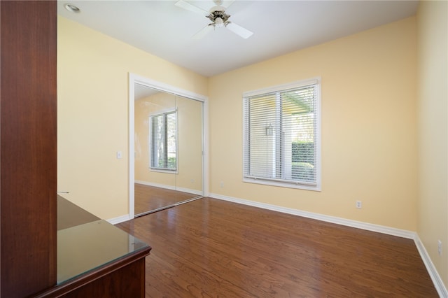 empty room featuring ceiling fan and dark hardwood / wood-style flooring