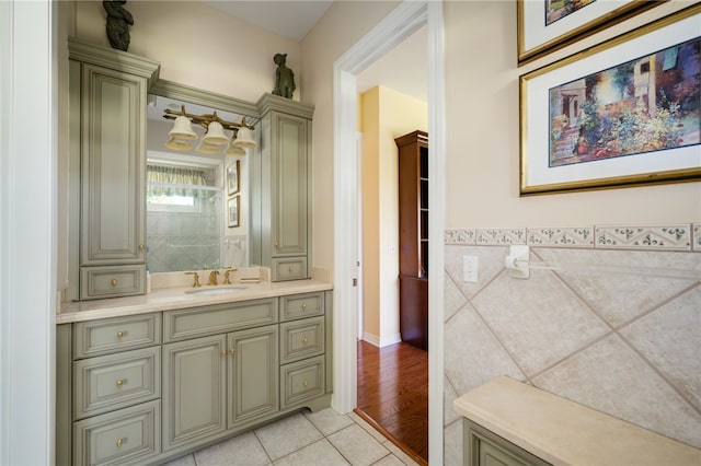 bathroom with tile walls, vanity, and hardwood / wood-style floors