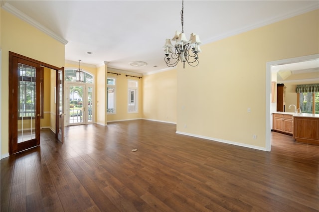 spare room with french doors, a notable chandelier, dark hardwood / wood-style floors, and crown molding