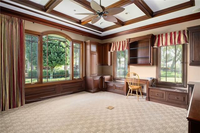 carpeted home office with a healthy amount of sunlight, built in desk, crown molding, and coffered ceiling