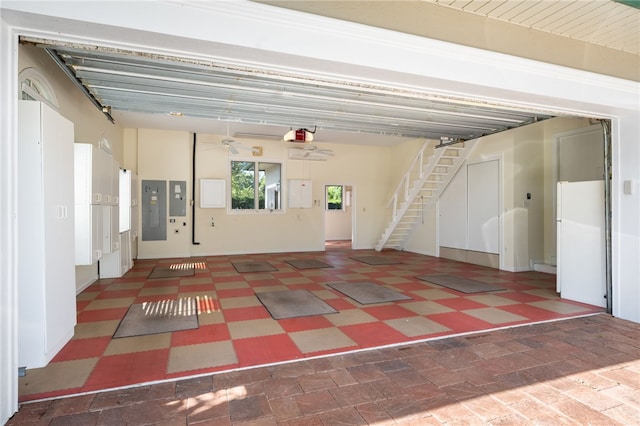 garage featuring electric panel and a garage door opener