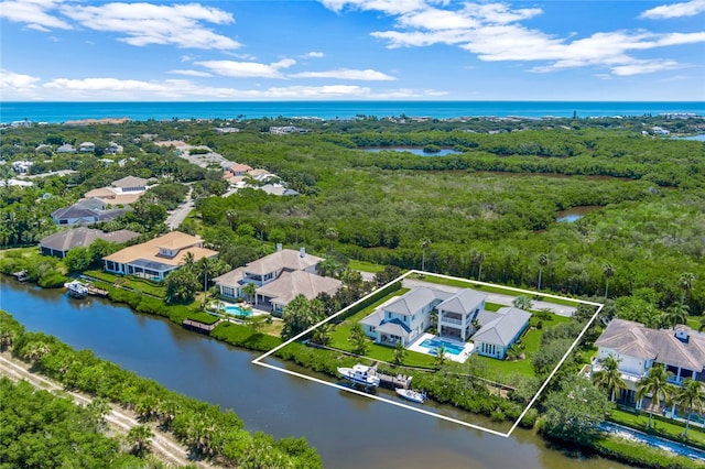 birds eye view of property with a water view