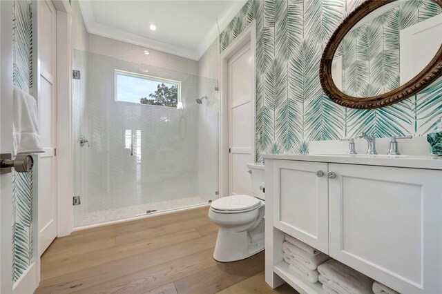 bathroom featuring crown molding, vanity, an enclosed shower, hardwood / wood-style flooring, and toilet