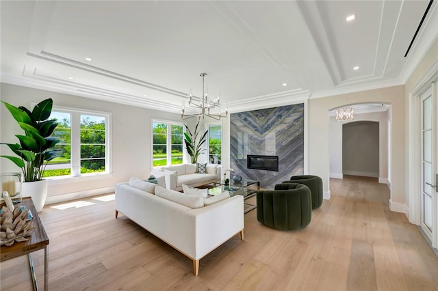 living room featuring crown molding and light hardwood / wood-style flooring