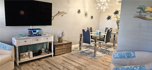 home office with a chandelier and wood-type flooring