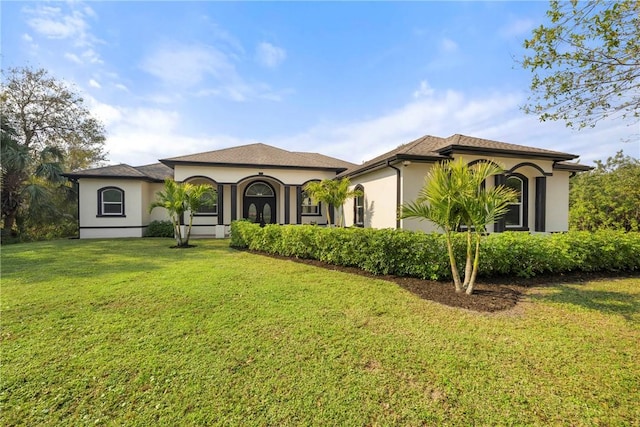 mediterranean / spanish-style house featuring a front lawn