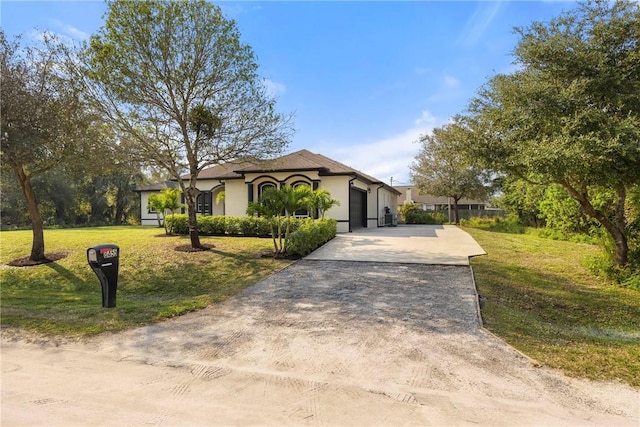 view of front of property with a front yard and a garage