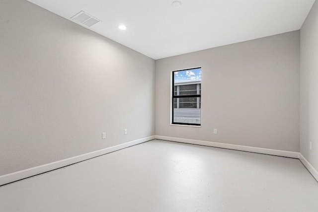 unfurnished room with concrete flooring