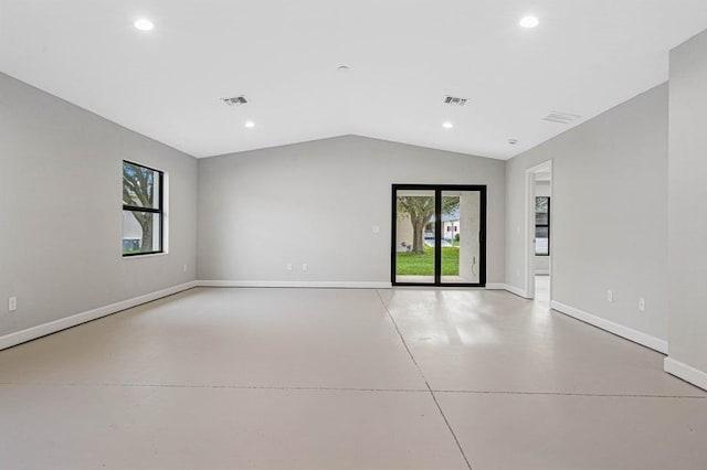 empty room featuring lofted ceiling