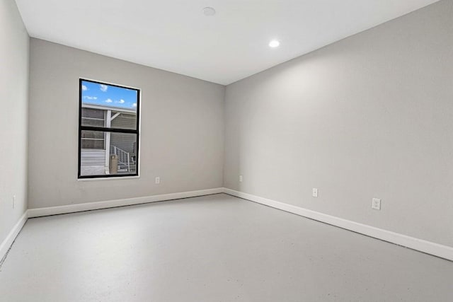 unfurnished room featuring concrete flooring