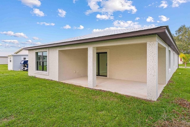 back of property featuring a yard and a patio