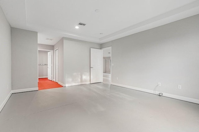 unfurnished bedroom featuring concrete flooring and connected bathroom