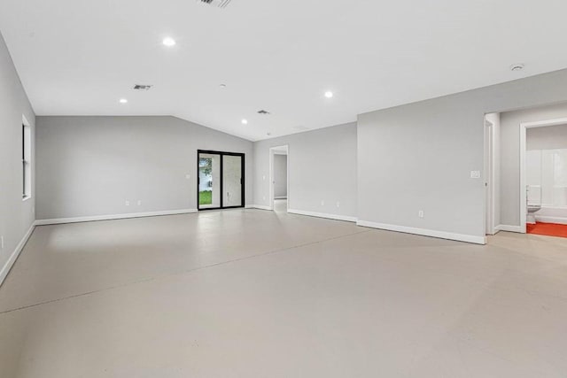 unfurnished room with vaulted ceiling