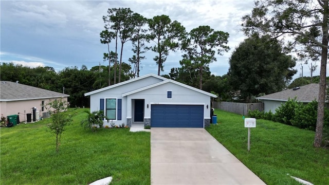 single story home featuring a garage and a front lawn