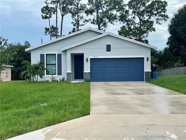 view of front of property with a front yard and a garage