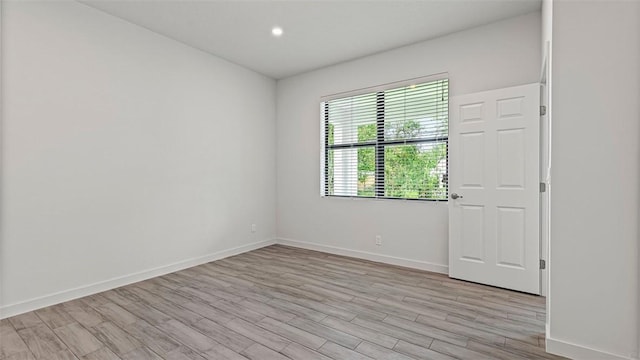 unfurnished room with light wood-type flooring