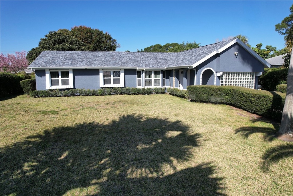 ranch-style house with a front lawn