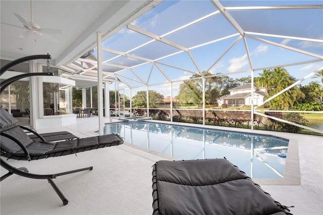 view of swimming pool featuring ceiling fan, a patio, and glass enclosure