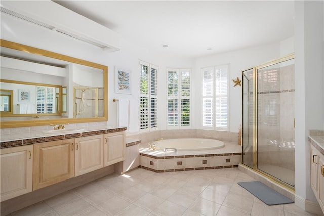 bathroom with separate shower and tub, tile patterned flooring, and vanity