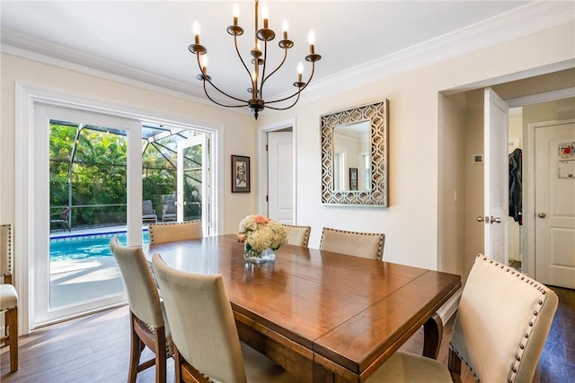 dining area featuring crown molding, dark wood-type flooring, and an inviting chandelier