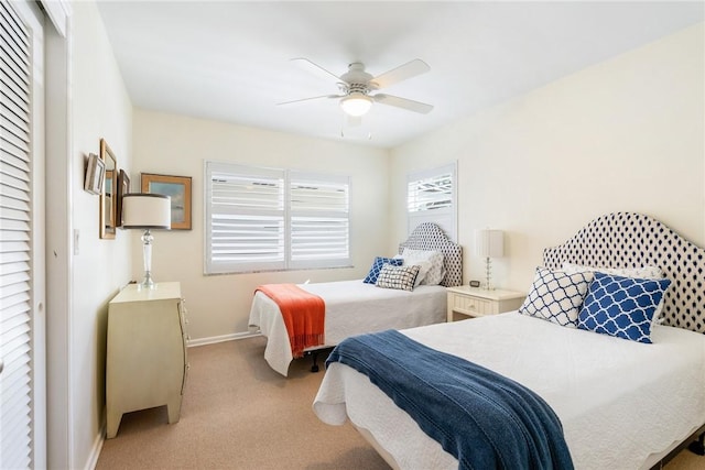 carpeted bedroom with ceiling fan and a closet