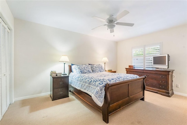 carpeted bedroom featuring ceiling fan and a closet