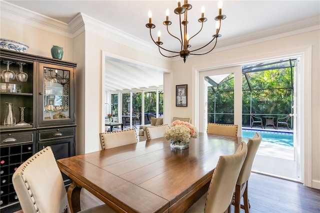 dining area featuring crown molding, dark hardwood / wood-style floors, and an inviting chandelier