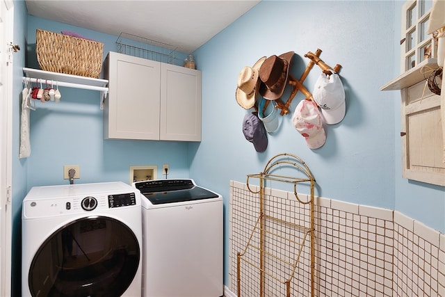 laundry area with cabinets and separate washer and dryer