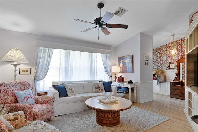 living room with ceiling fan, light hardwood / wood-style flooring, and lofted ceiling