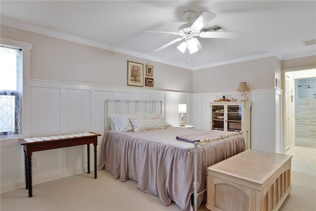 carpeted bedroom featuring connected bathroom, ceiling fan, and crown molding