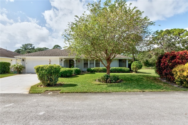 view of front of property with a garage and a front yard