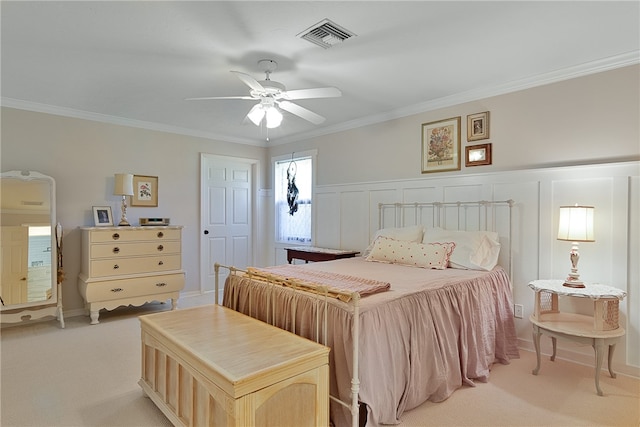 bedroom featuring light carpet, ceiling fan, and crown molding