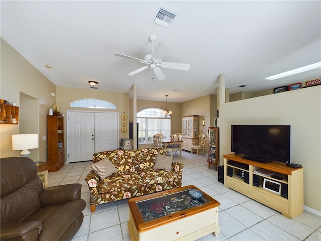 tiled living room featuring ceiling fan with notable chandelier