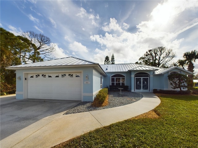 ranch-style home featuring a standing seam roof, metal roof, and stucco siding