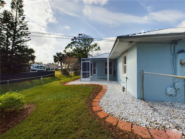 view of yard featuring a sunroom