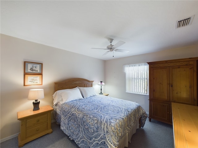 bedroom featuring dark colored carpet and ceiling fan