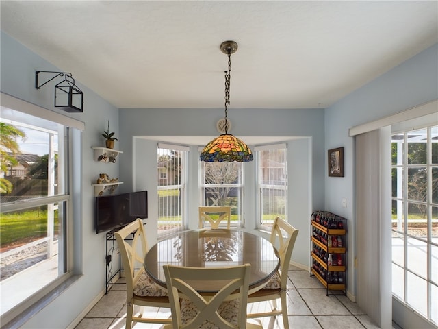 tiled dining space with a healthy amount of sunlight