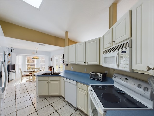 kitchen featuring sink, decorative light fixtures, light tile patterned floors, kitchen peninsula, and white appliances