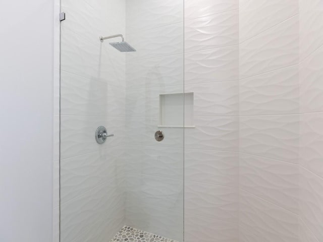 bathroom with a tile shower