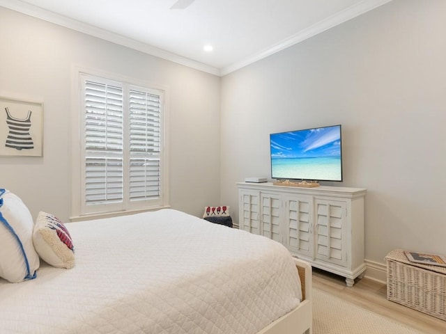 bedroom with crown molding and light hardwood / wood-style flooring